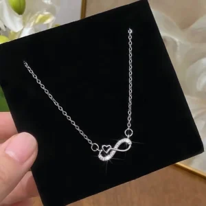 Sterling silver infinity heart pendant necklace with cubic zirconia on velvet display
