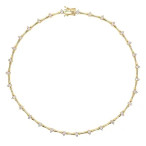 Gold cubic zirconia tennis choker necklace with pear-cut stations on model's neck